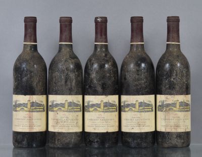 six bottles of wine are lined up on a table