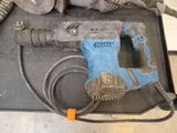 a blue and black drill and some other tools on a table