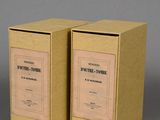 pair of two boxes with labels on them sitting on a table