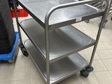 a metal cart that is sitting in a kitchen