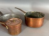 three pots and pans sitting on a table