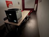 a table with a printer on it in the middle of a room