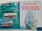 two books on a table with pictures of ships and a boat