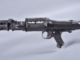 an old gun that is on display on a white surface