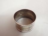 a silver ring that is sitting on a table