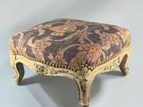 a foot stool with a floral upholstered seat