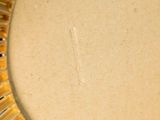 a picture of a gold necklace on a white table