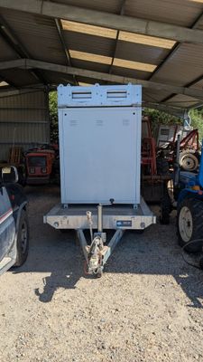 a white refrigerator sitting in the back of a trailer