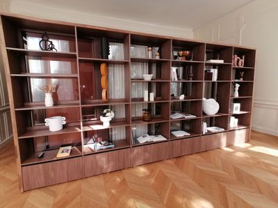 a large wooden bookcase with many shelves and vases on it