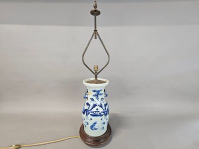 a blue and white lamp that is sitting on a table