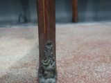 a close up view of a wooden table with a statue on top of it