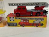 a red fire truck and a yellow firetruck on a table