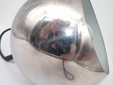 someone is taking a picture of themselves in the mirror of a large silver object