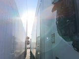 a picture of a view of the sun through the window of a bus