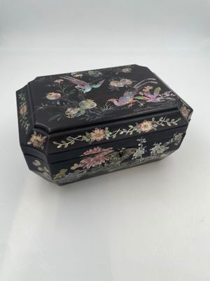 an image of a black box with a floral design on it