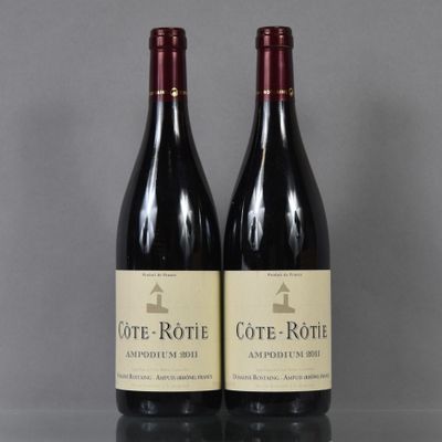 two bottles of wine sitting on top of a table next to each other