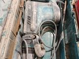 a box with a drill and other tools in it