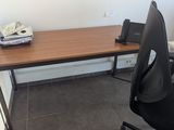 a desk with a chair and a phone on it