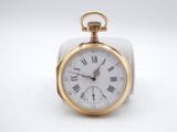 a gold pocket watch with roman numerals on it