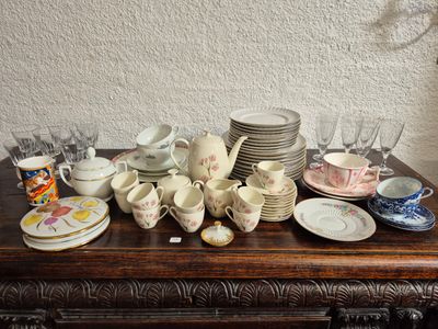 a table with a lot of dishes and cups on it
