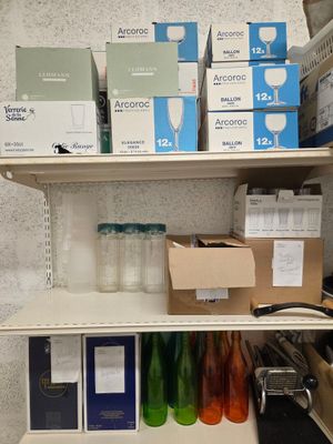 many boxes and bottles on the shelves in the room