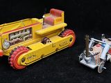 two toy vehicles that are sitting next to each other