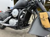 a motorcycle parked in a garage with a bag on the back of it
