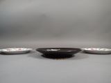 three small bowls sitting on a table with one bowl in the middle