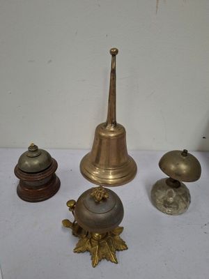 four different types of bells on a table