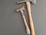 an old axe and an old axe on a gray surface