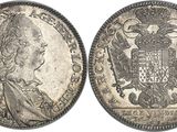 a silver coin with an eagle on the front and a crown on the back