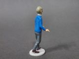 a figurine of a man standing on a white base