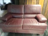 a brown leather couch that is sitting in a room
