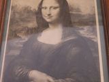 framed picture of a painting of a woman ' s face in a wooden frame