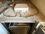 two pictures of a room that has a lot of wires on the floor