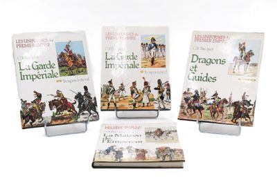 three books on display on a white surface with one of them in front of the other
