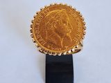an image of a gold coin on a black stand