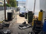 an image of a garage that has a lot of junk on the ground