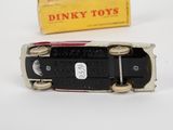 a small toy car that is sitting next to a box of dinky toys