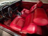 the interior of a car with red leather seats and a steering wheel