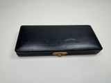 a black leather case with a gold clasp on it