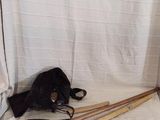 a black bag and a pair of wooden skis on a white sheet