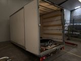a large white truck that is parked in a garage