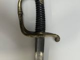 an old sword with a gold handle on a white surface