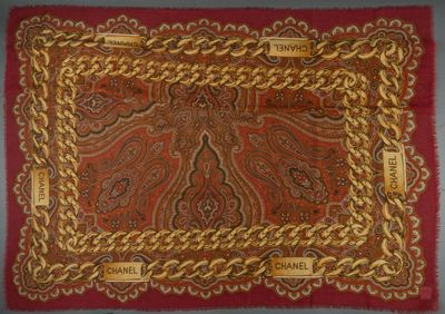 an image of a red and gold scarf with gold chains on it