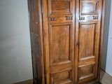 a large wooden cabinet in the corner of a room