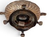 a metal object that is sitting on a white surface