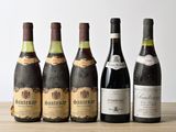 six bottles of wine are lined up on a wooden table