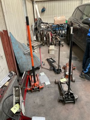 two men working on a car in a garage