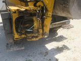 a large yellow machine that is sitting in the dirt
